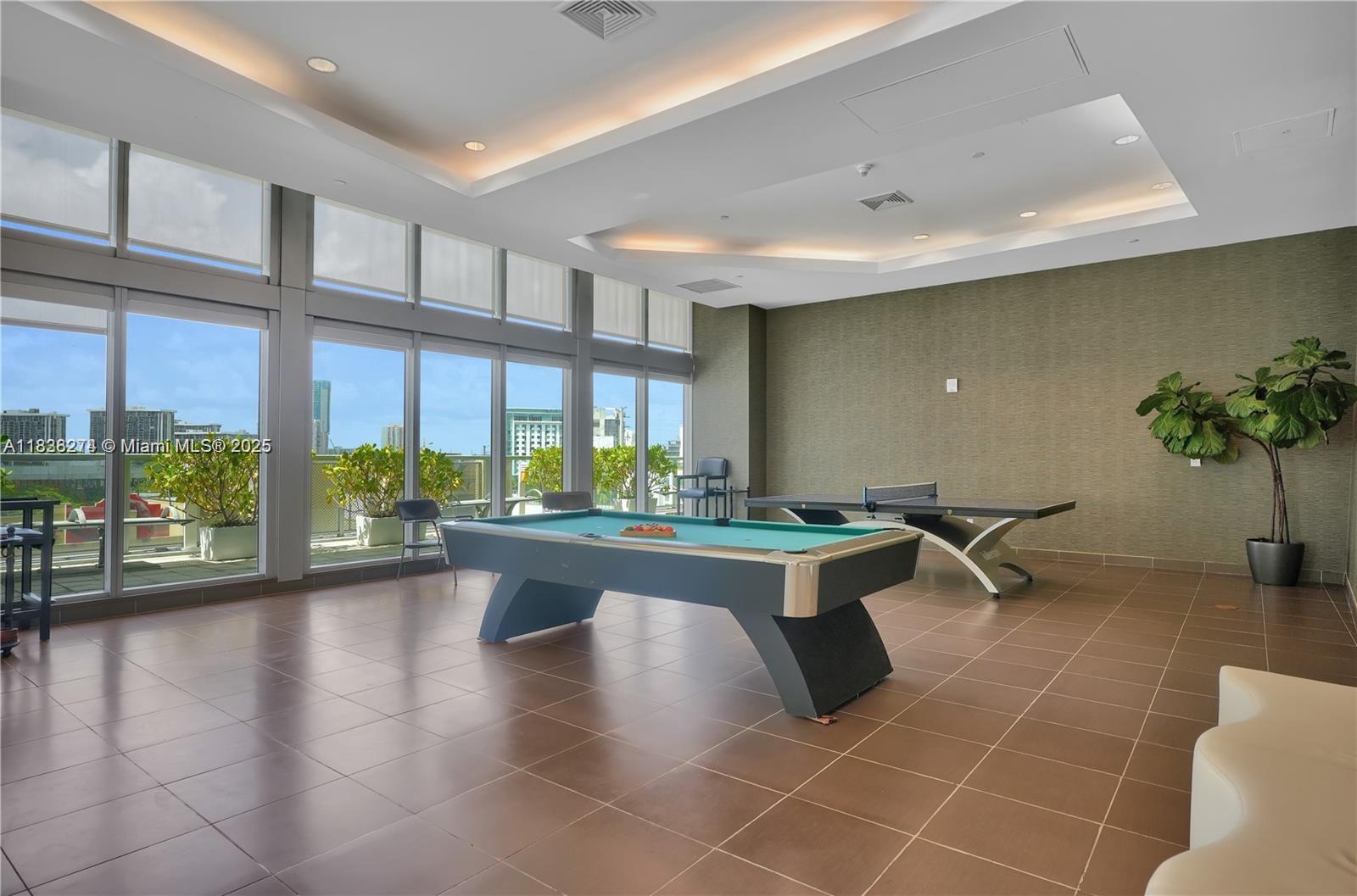 1111 Southwest 1st Avenue, Unit 2823N Miami, FL 33130 - Photo 16 of 22 a living room with furniture a floor to ceiling window and wooden floor