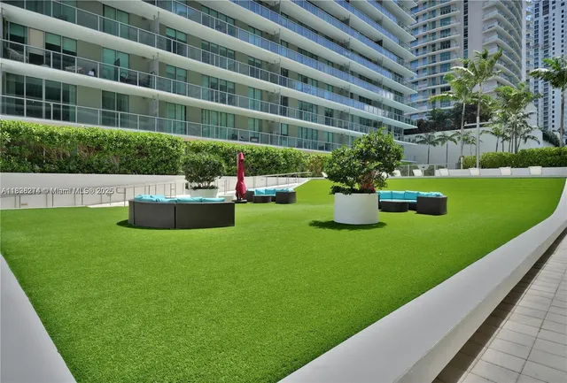a view of a house with backyard sitting area and garden