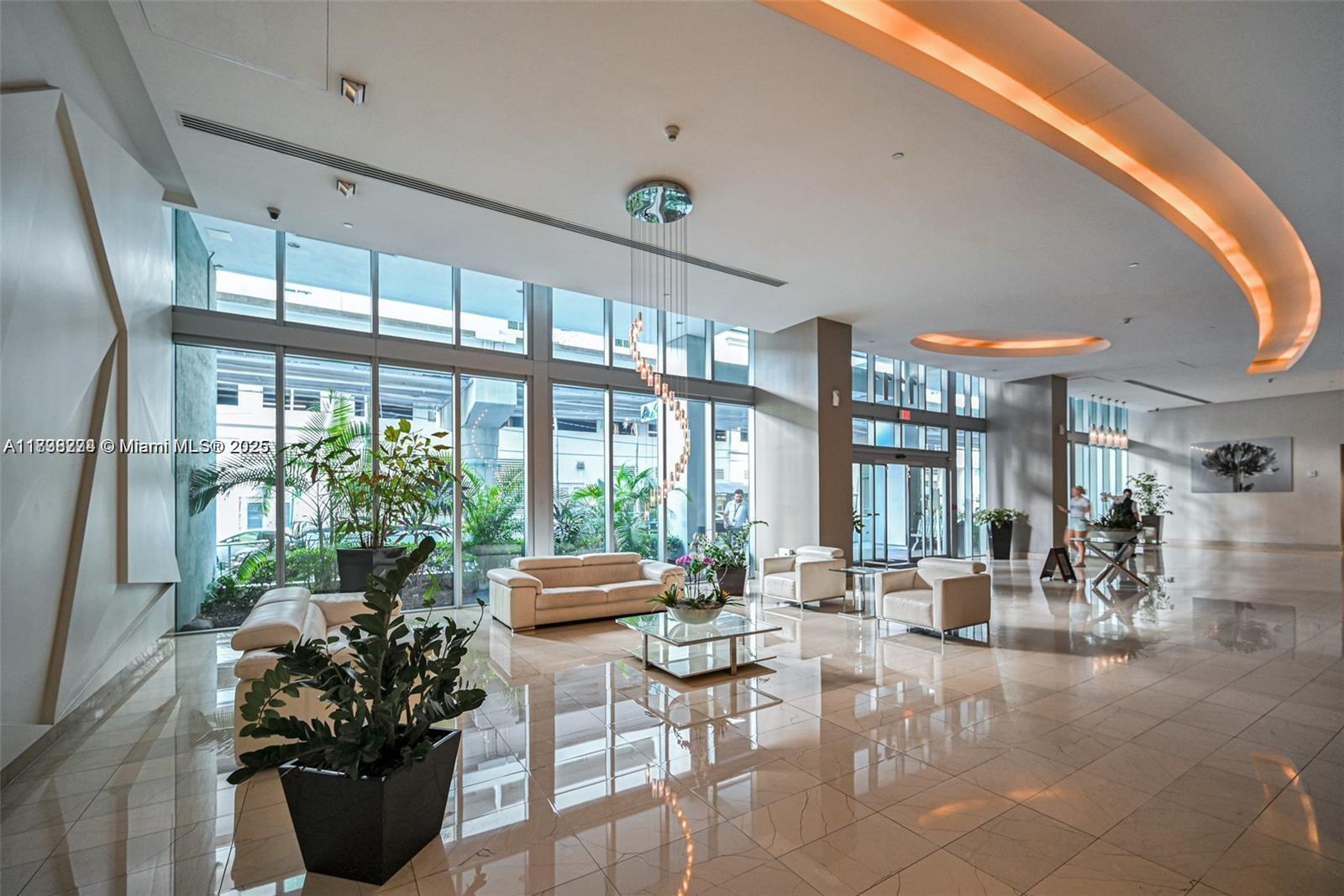 1111 Southwest 1st Avenue, Unit 2823N Miami, FL 33130 - Photo 3 of 22 a lobby with furniture and potted plants