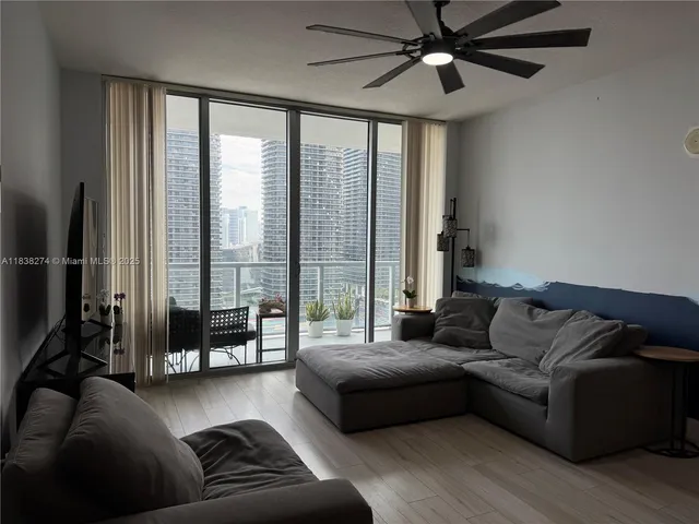 a living room with furniture and a large window