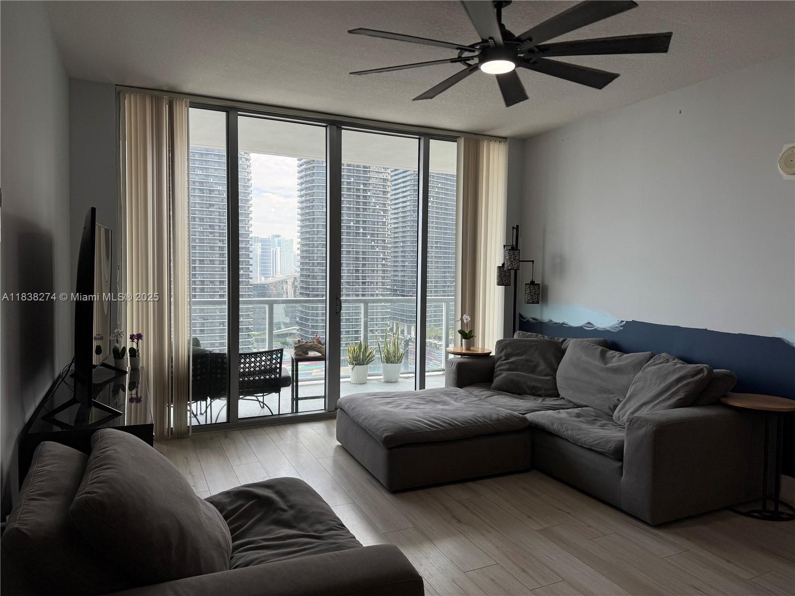 1111 Southwest 1st Avenue, Unit 2823N Miami, FL 33130 - Photo 8 of 22 a living room with furniture and a large window