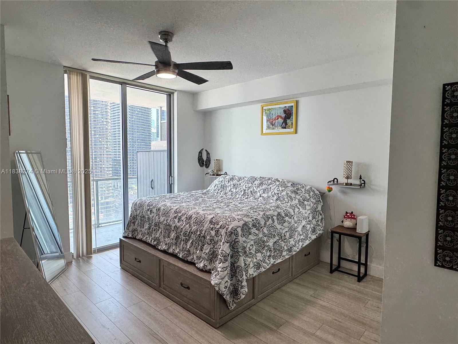 1111 Southwest 1st Avenue, Unit 2823N Miami, FL 33130 - Photo 9 of 22 a bed sitting in a bedroom next to a window