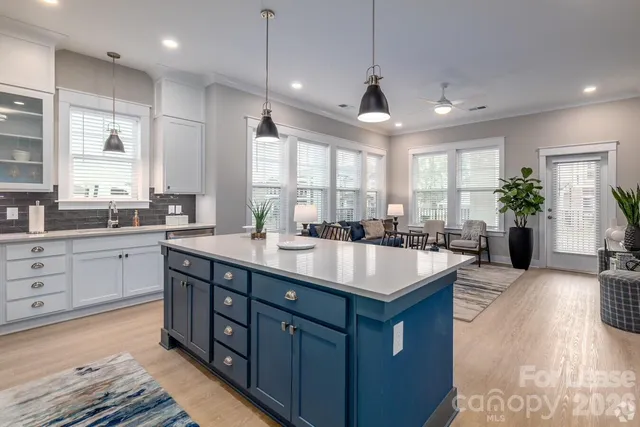 a kitchen with a stove a sink and a refrigerator
