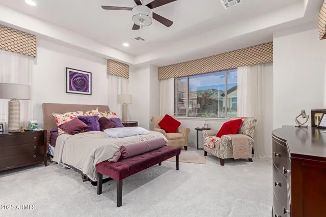 a bedroom with bed and a large window