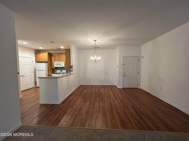 a view of a kitchen with wooden floor and a kitchen