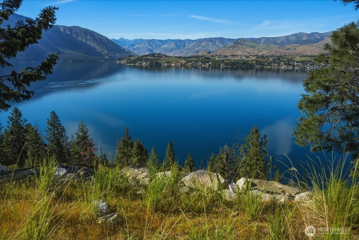 7365 Ridgeview Drive Chelan, WA 98816 - Photo 1 of 17 a view of a lake with a mountain in the background