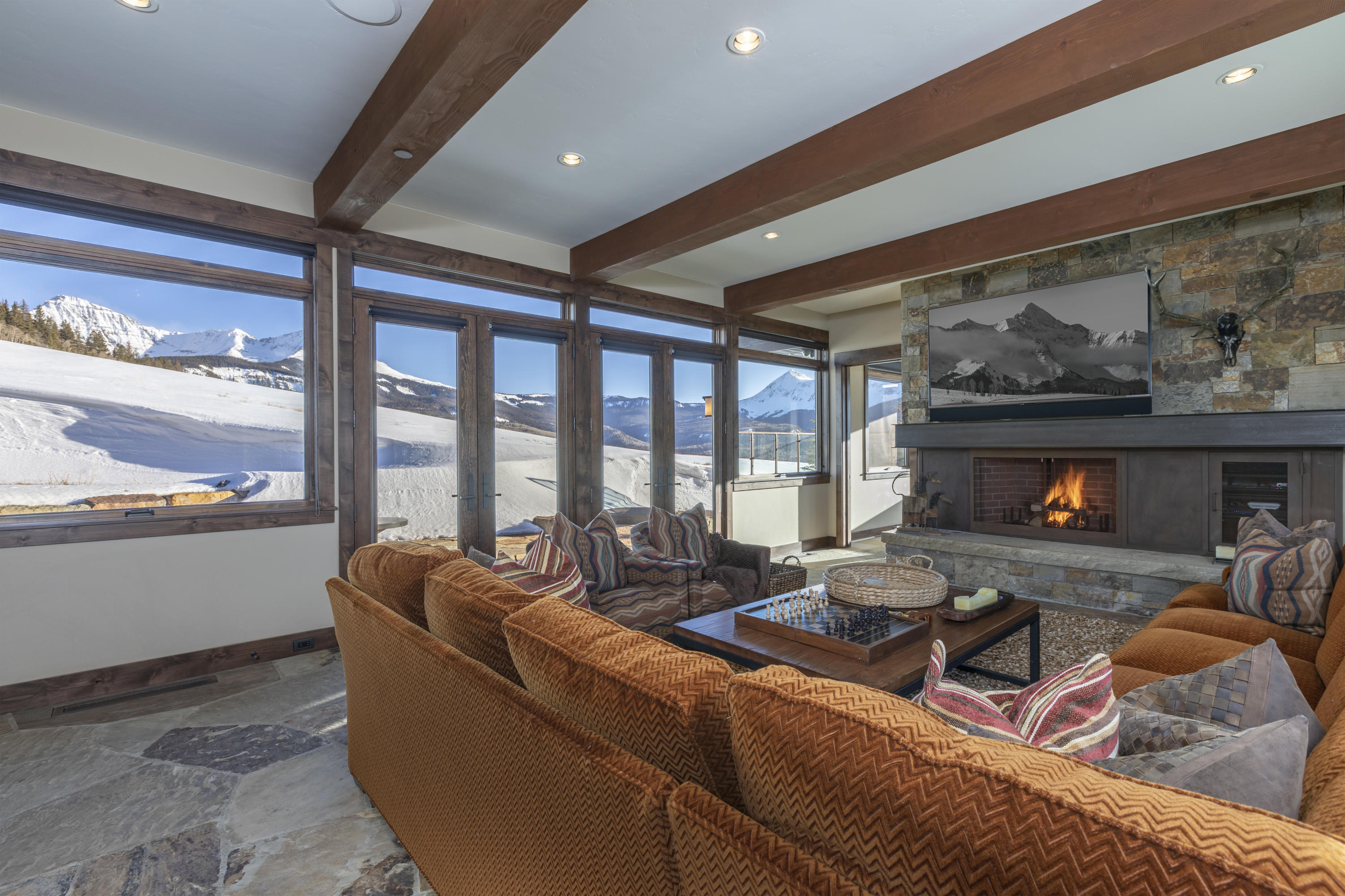 397 Muddy Creek Placerville, CO 81430 - Photo 16 of 22 a living room with furniture a fireplace and a floor to ceiling window