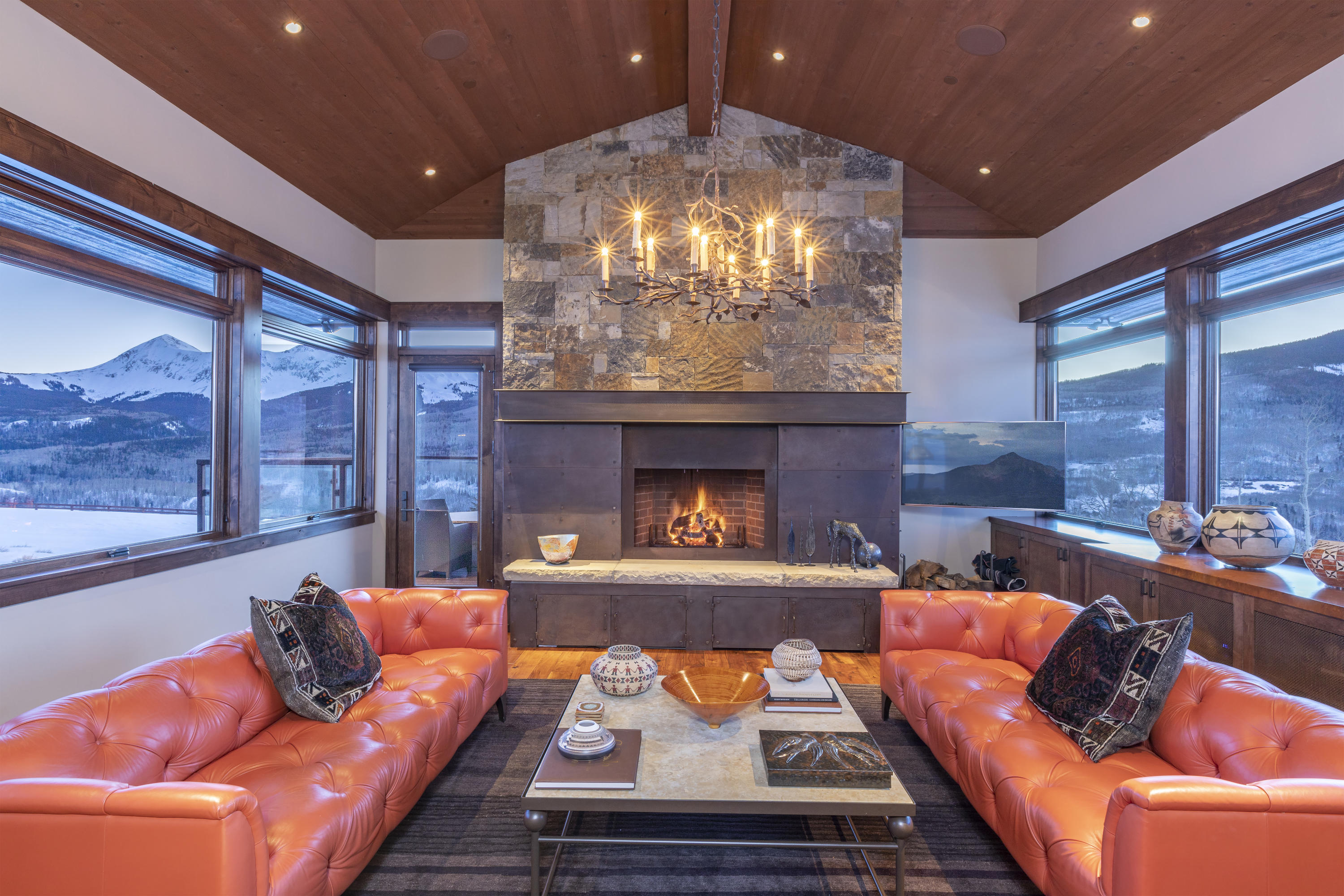 397 Muddy Creek Placerville, CO 81430 - Photo 4 of 22 a living room with furniture a fireplace and a chandelier