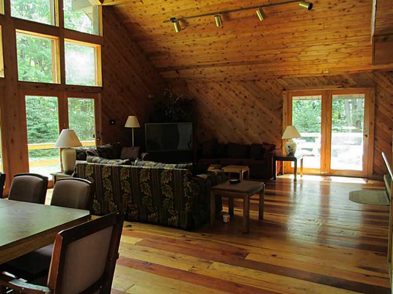 147 Fire Tower Road Champion, PA 15622 - Photo 3 of 21 Great Room. All wood floors throughout the great room, kitchen and hall. With doors on both sides to the huge decks!