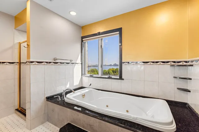 a bathroom with a tub and a shower