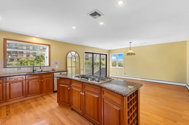 a kitchen with stainless steel appliances granite countertop a sink and cabinets