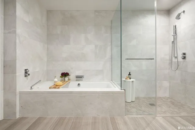 a bathroom with a tub and shower