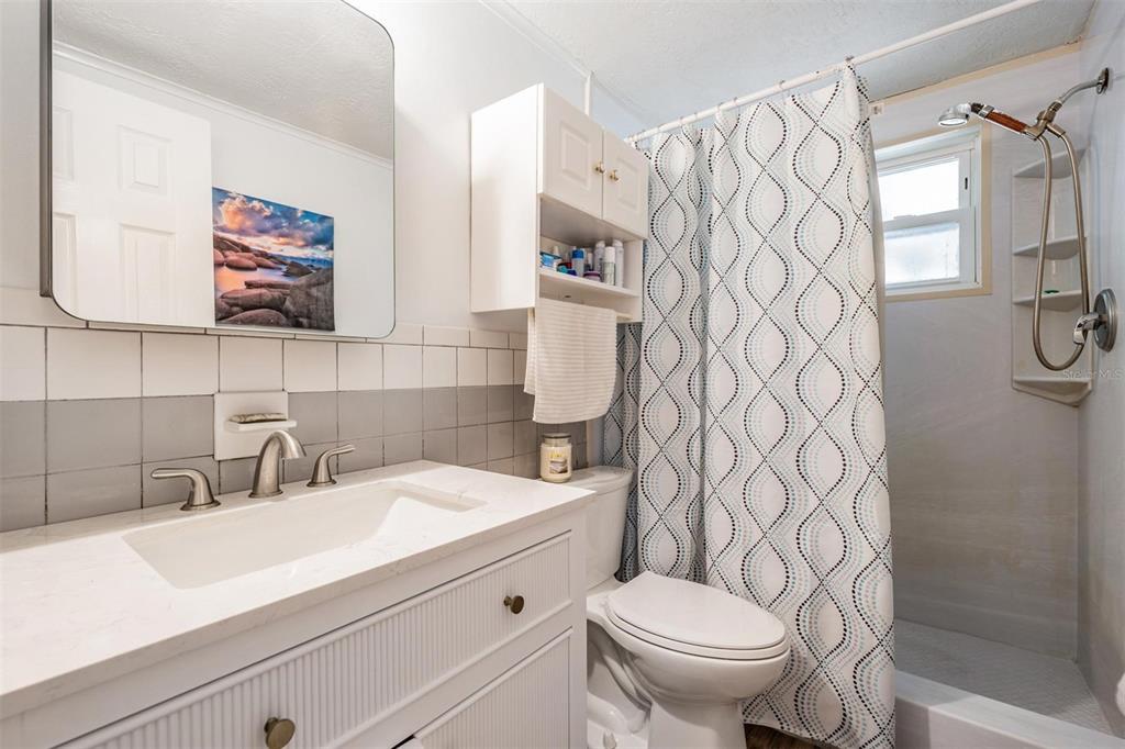 3608 Umber Road Holiday, FL 34691 - Photo 11 of 20 a bathroom with a toilet sink and mirror