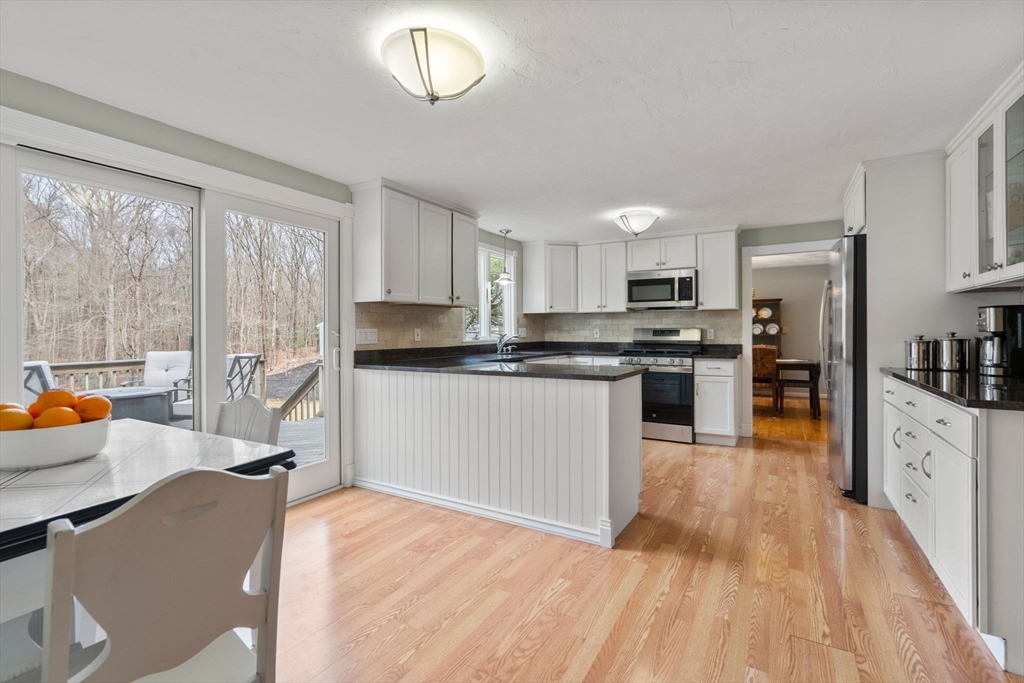 80 Oak Hill Drive Sharon, MA 02067 - Photo 3 of 36 a kitchen with stainless steel appliances granite countertop a refrigerator oven a sink dishwasher and white cabinets with wooden floor