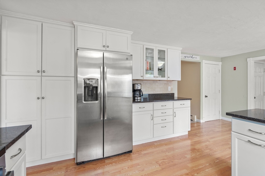 80 Oak Hill Drive Sharon, MA 02067 - Photo 6 of 36 a kitchen with white cabinets and stainless steel appliances