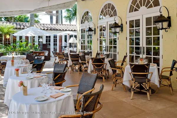 a view of a building with dining table and chairs