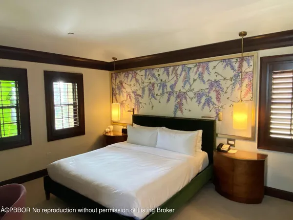 a bedroom with a large bed and window