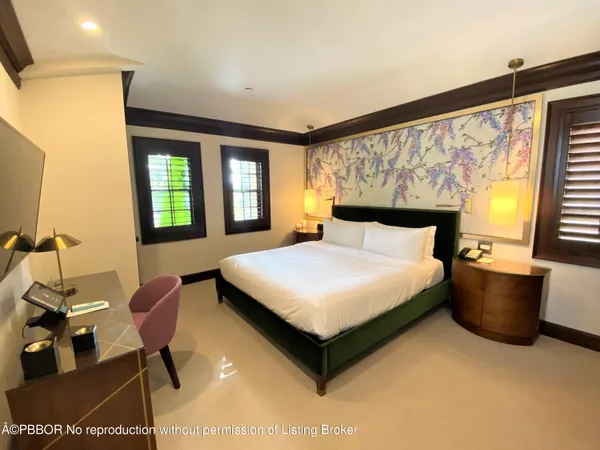 a bedroom with a bed chair and window