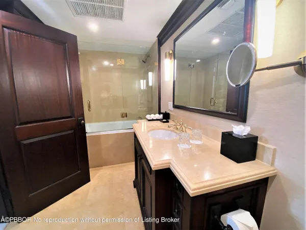 a bathroom with a sink a toilet a shower and a mirror