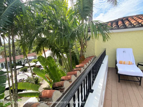 a view of a balcony with chairs