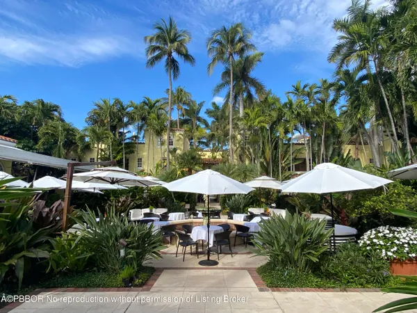 a view of patio with chairs and potted plants