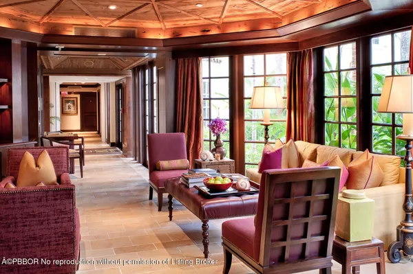 a living room with furniture and large windows
