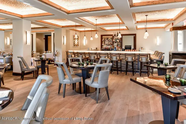 a dining hall view with a large dining table and chairs