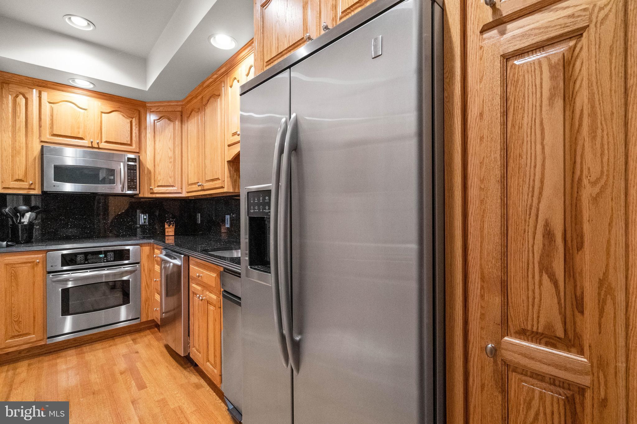 37120 Devon Wick Lane Purcellville, VA 20132 - Photo 55 of 66 a kitchen with stainless steel appliances granite countertop a refrigerator and a stove top oven