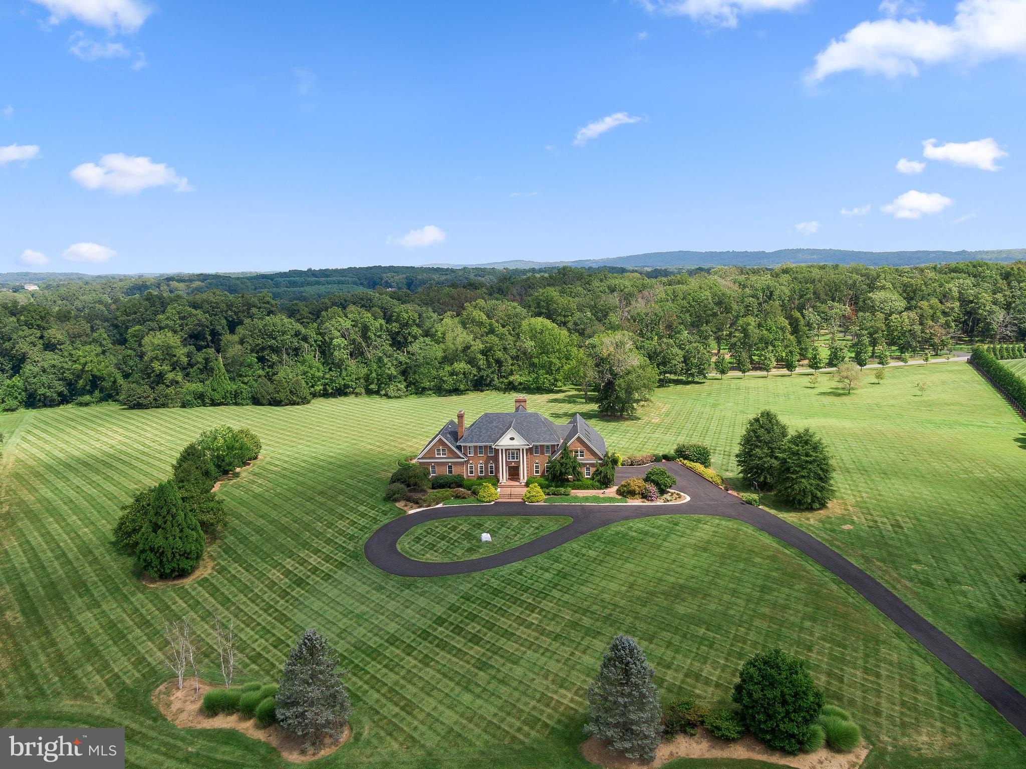 37120 Devon Wick Lane Purcellville, VA 20132 - Photo 63 of 66 a view of a lake with a yard