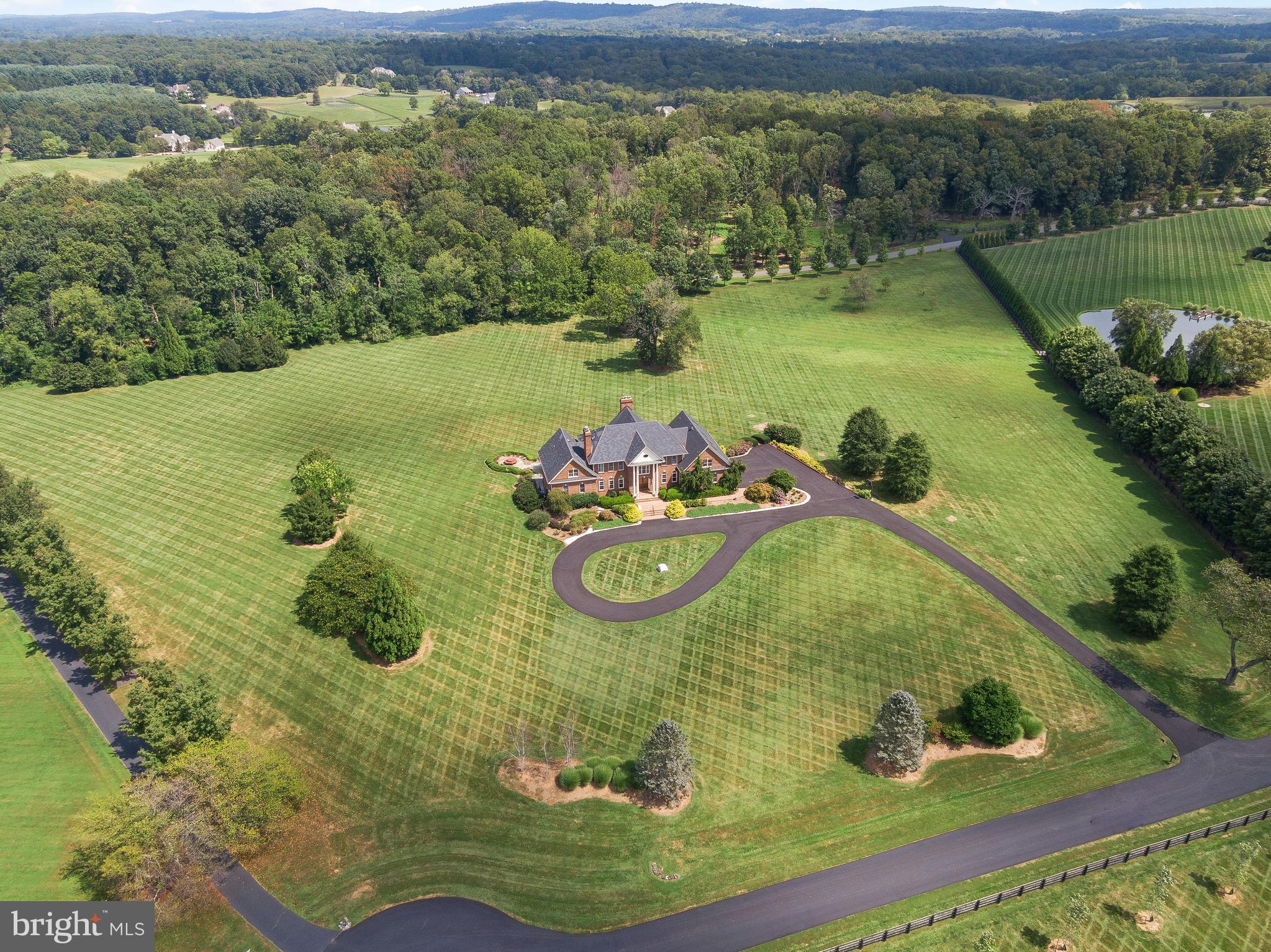 37120 Devon Wick Lane Purcellville, VA 20132 - Photo 7 of 66 a view of a swimming pool with a yard