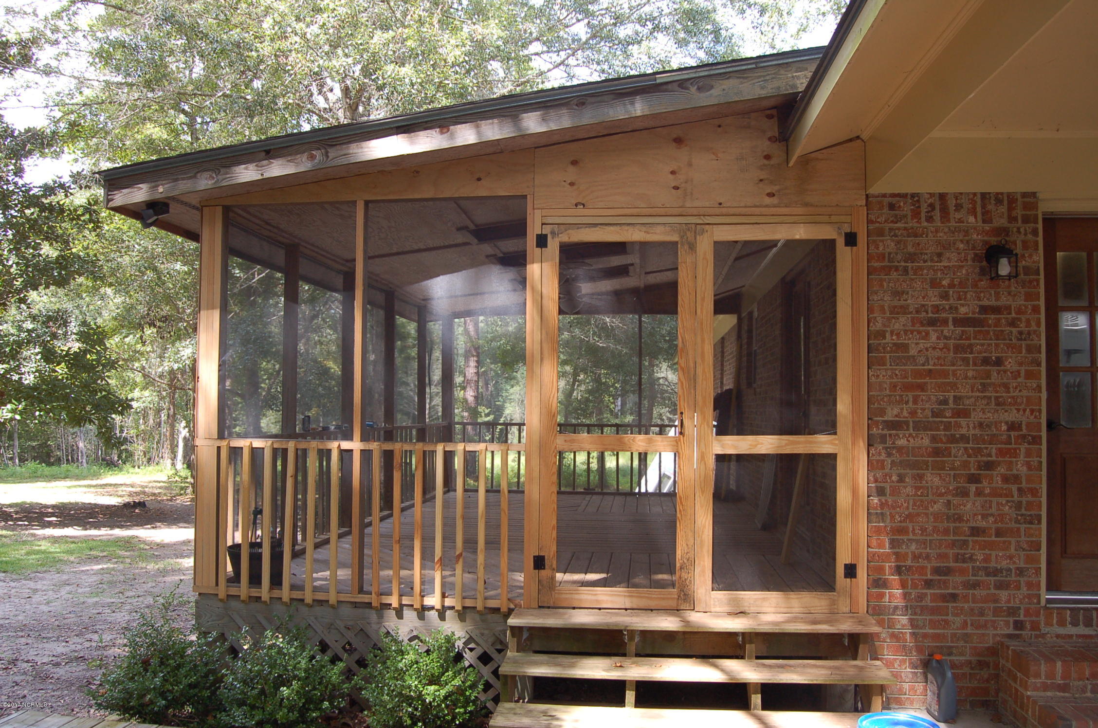 181 Oak Grove Road Newport, NC 28570 - Photo 3 of 17 Large screened porch great for entertaining. French doors lead to kitchen.