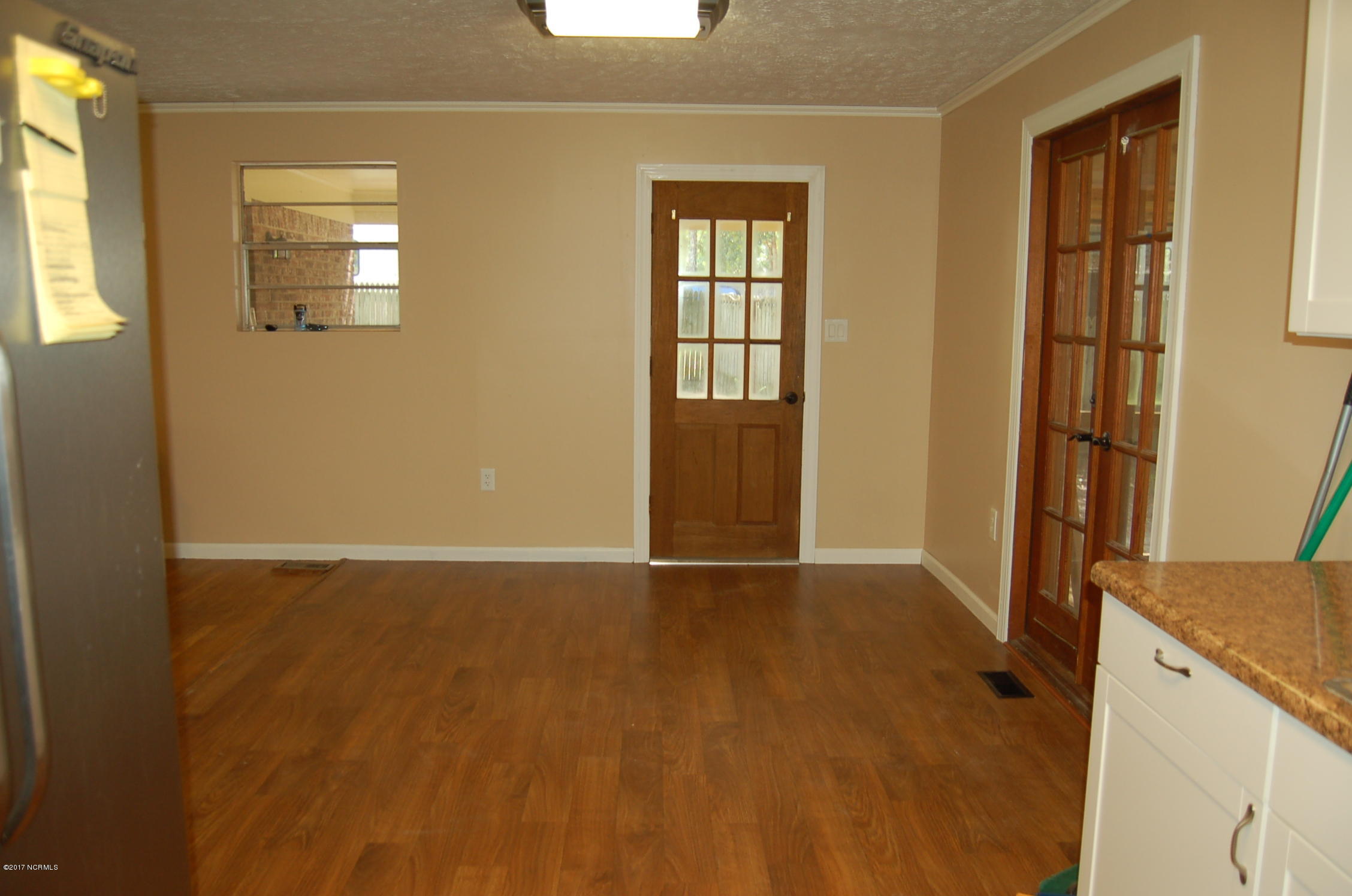 181 Oak Grove Road Newport, NC 28570 - Photo 7 of 17 Spacious dining area/kitchen combo open to the living room. There are beautiful french doors that lead to the large screened porch.