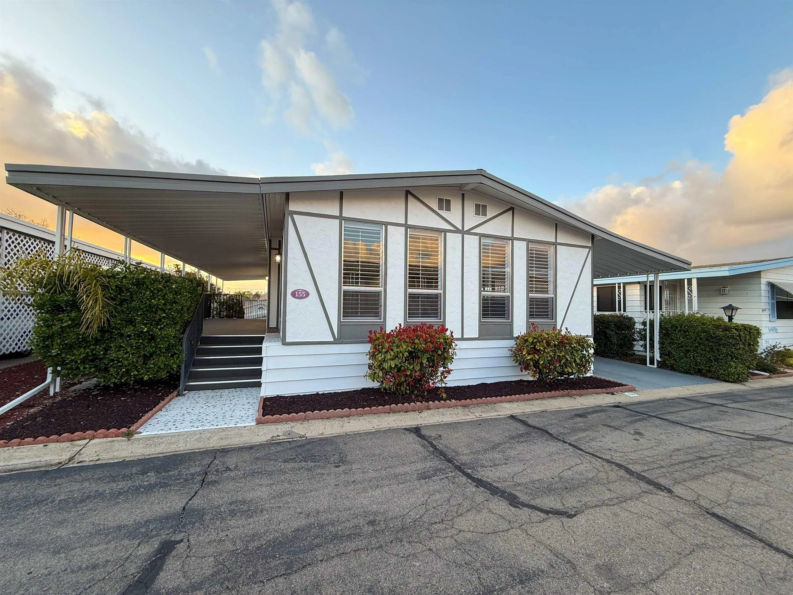 a front view of a house with a garden