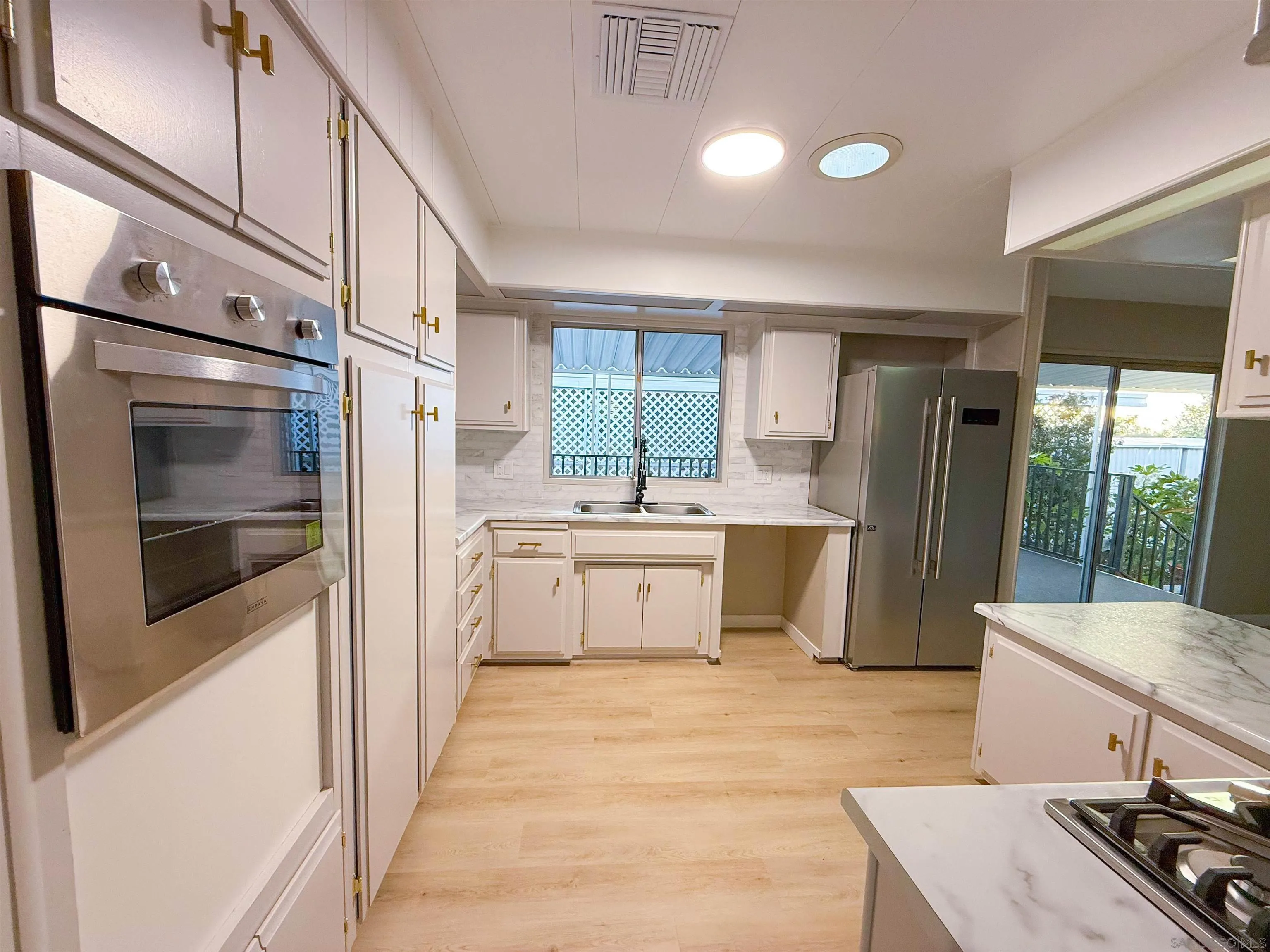 1212 H Street Ramona, CA 92065 - Photo 11 of 31 a kitchen with stainless steel appliances a stove a sink and a refrigerator