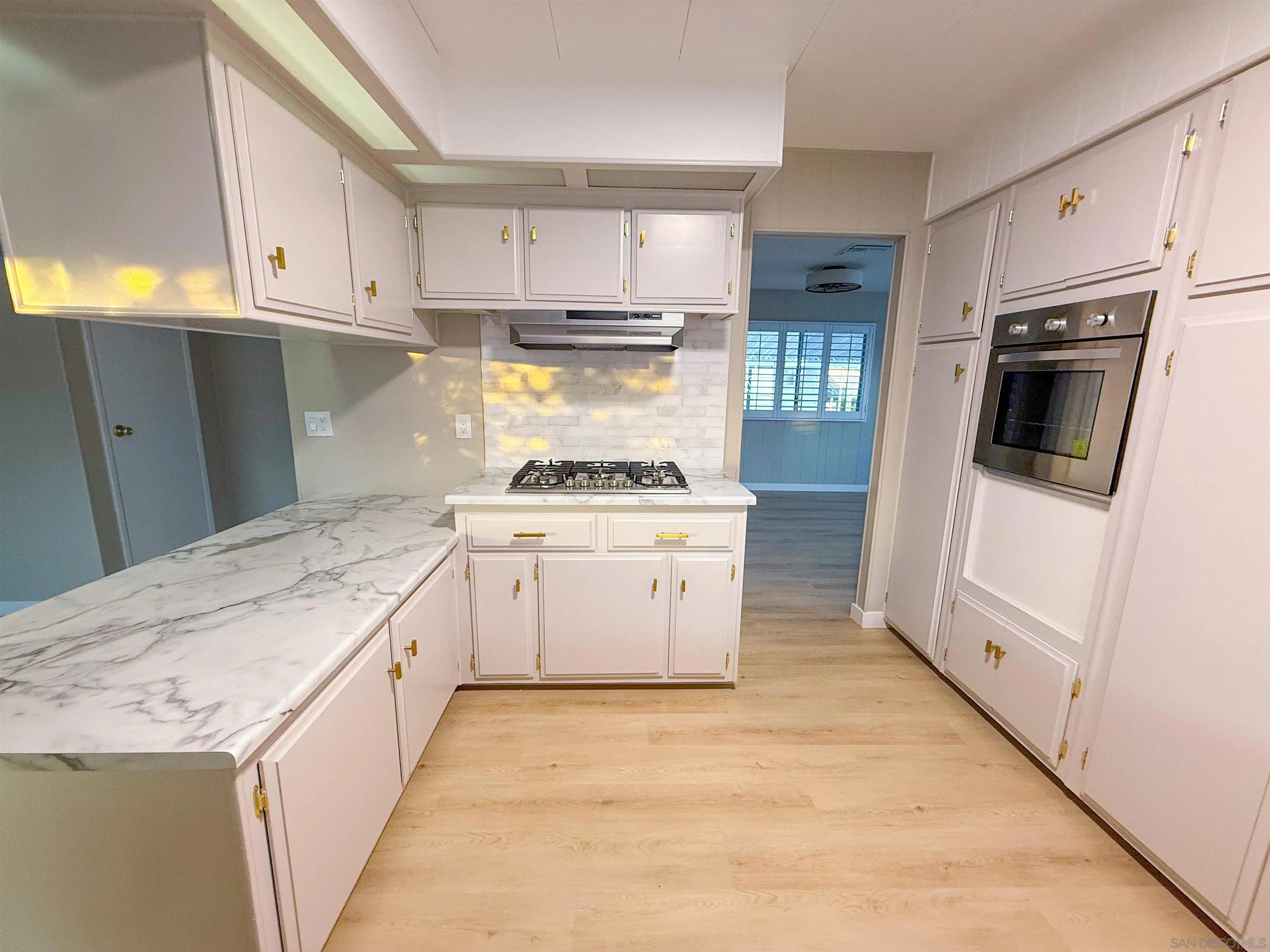 1212 H Street Ramona, CA 92065 - Photo 12 of 31 a kitchen with a stove microwave and refrigerator