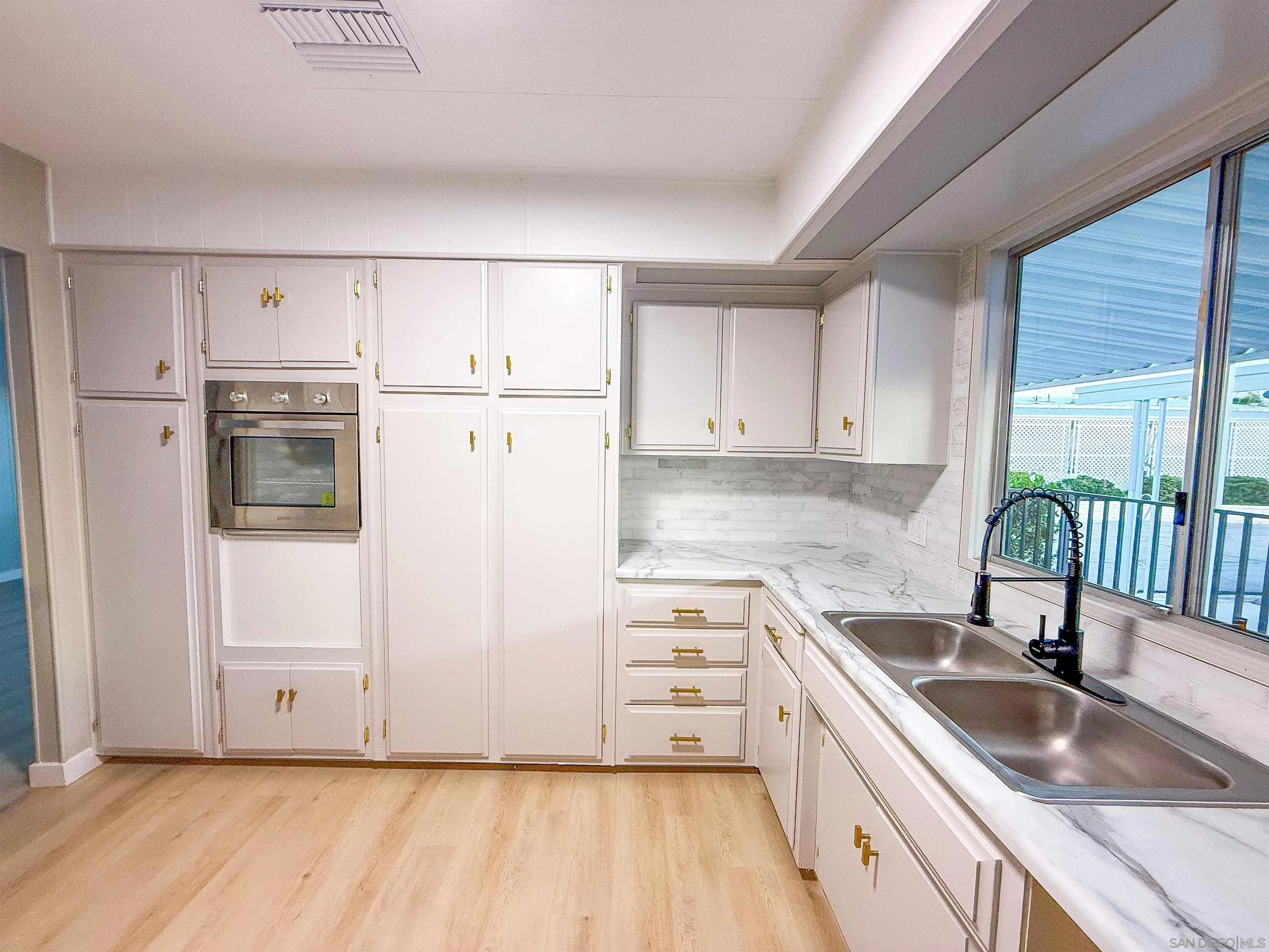 1212 H Street Ramona, CA 92065 - Photo 13 of 31 a kitchen with a sink a stove and refrigerator