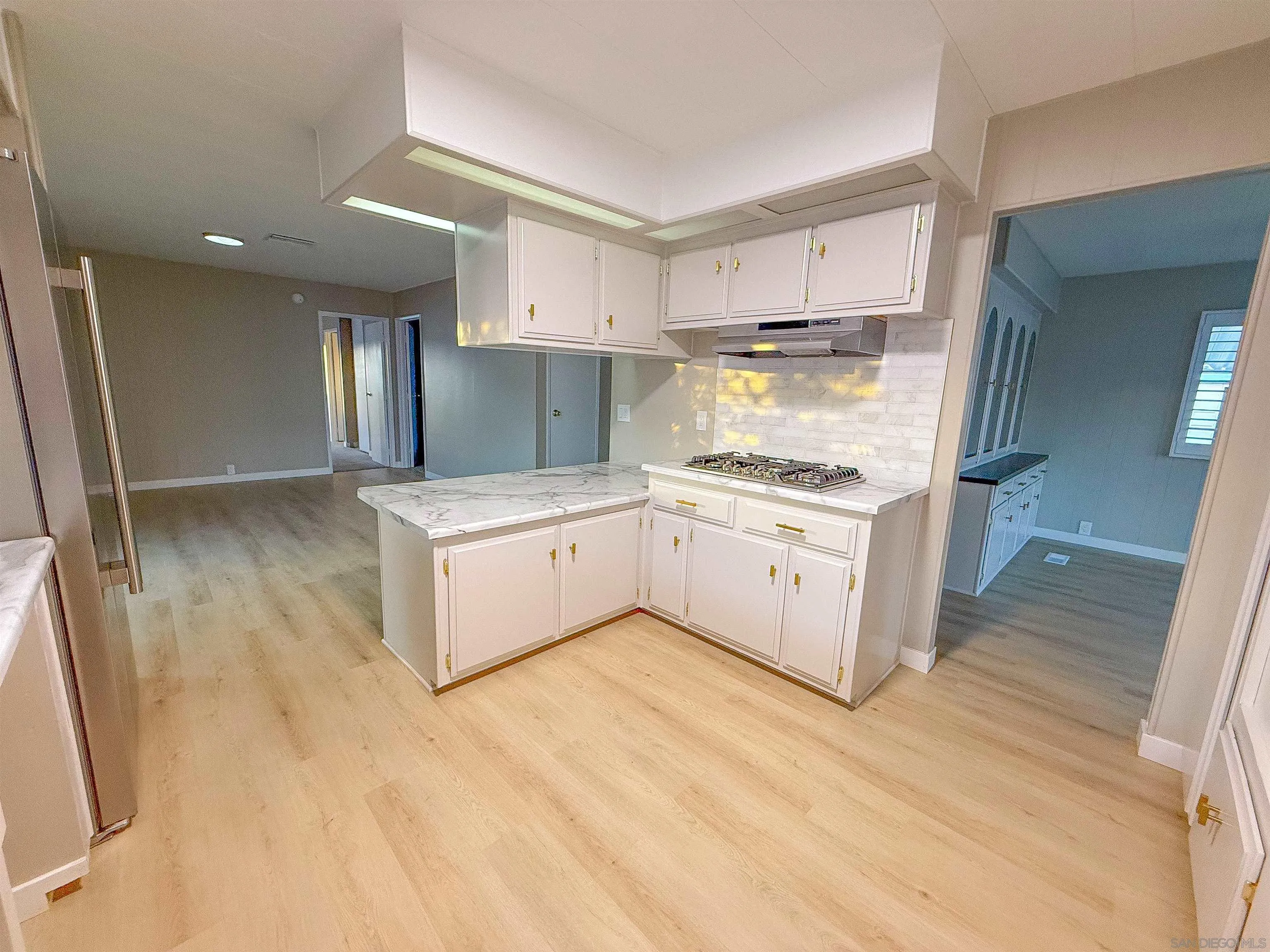 1212 H Street Ramona, CA 92065 - Photo 14 of 31 a kitchen with a sink a stove and cabinets