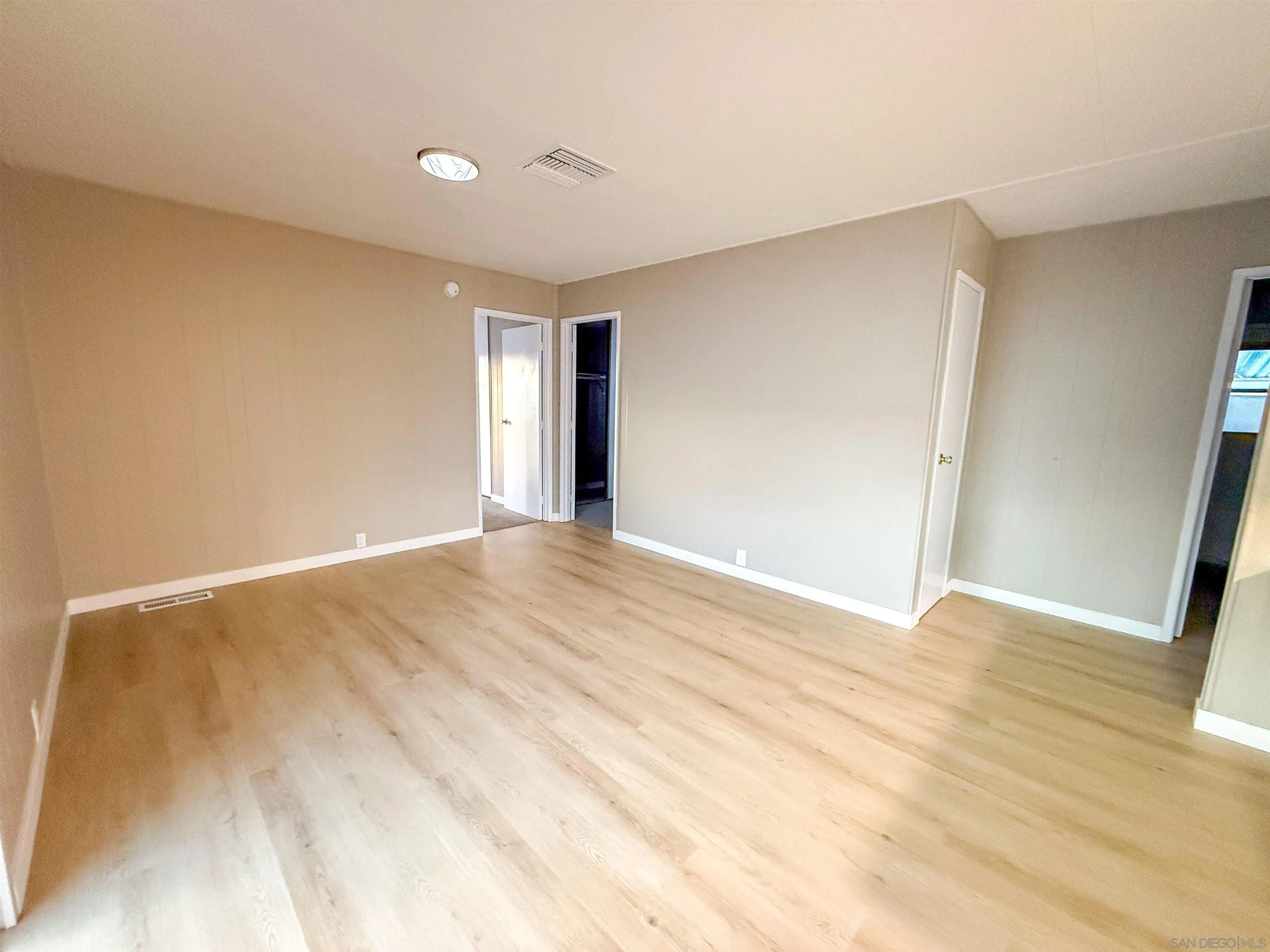 1212 H Street Ramona, CA 92065 - Photo 16 of 31 a view of an empty room with wooden floor