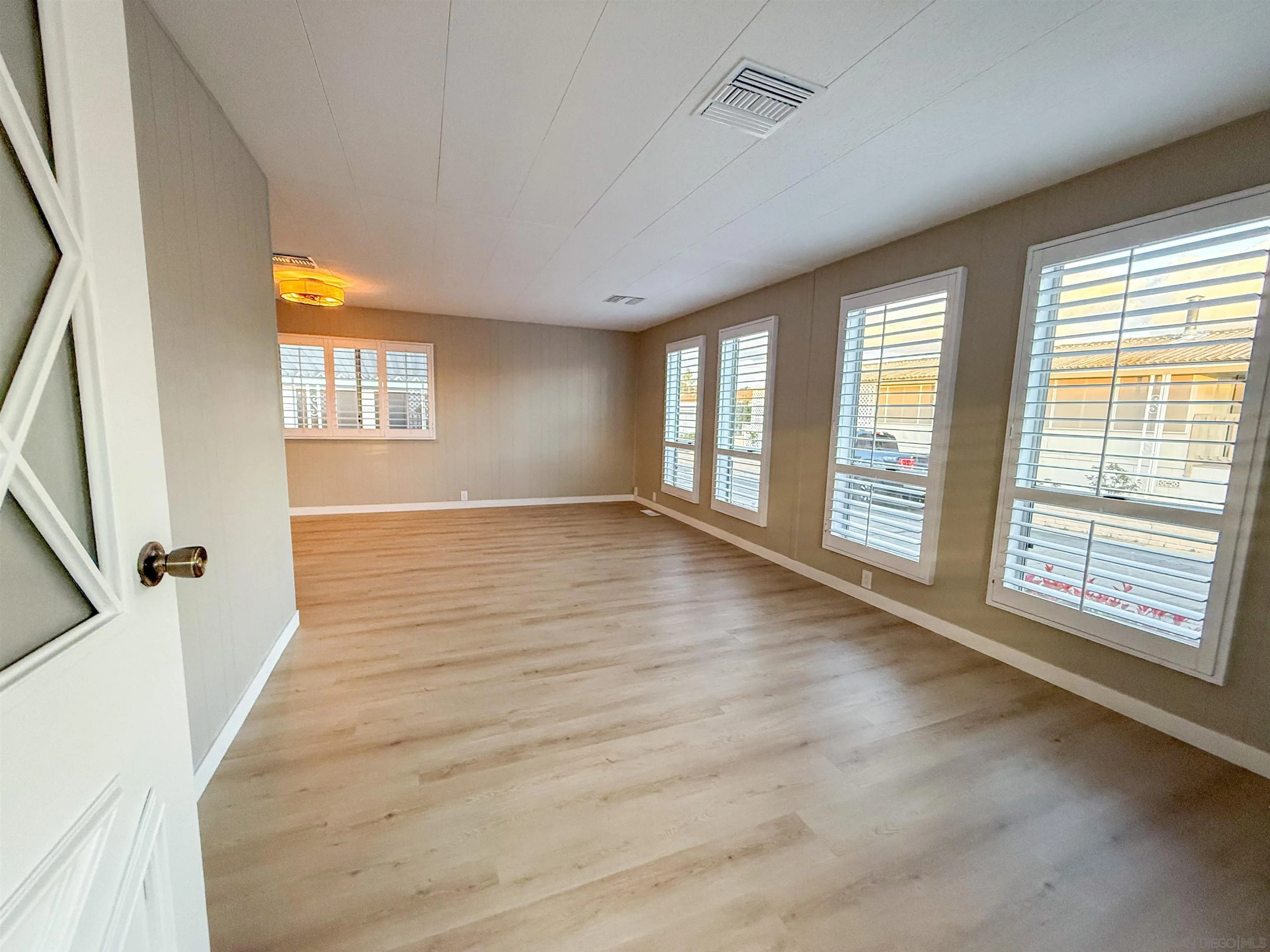 1212 H Street Ramona, CA 92065 - Photo 5 of 31 a view of an empty room with a window and wooden floor