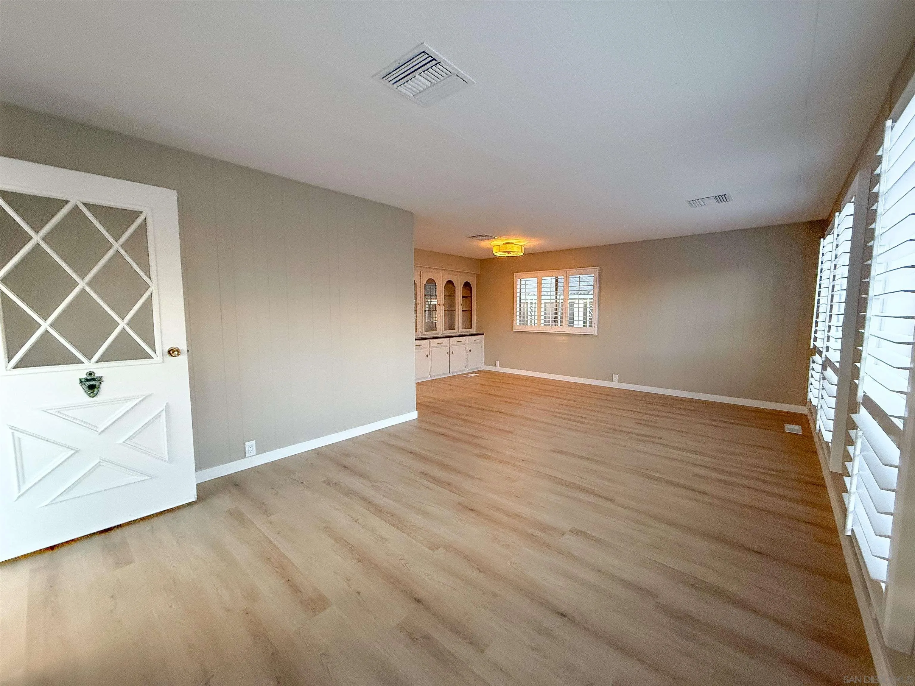 1212 H Street Ramona, CA 92065 - Photo 8 of 31 an empty room with wooden floor and windows