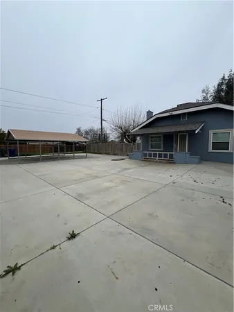 a backyard of a house with table and chairs