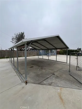 a backyard of a house with table and chairs