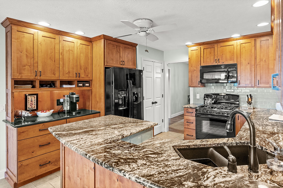 21 Pendleton Way Bloomington, IL 61704 - Photo 24 of 55 a kitchen with stainless steel appliances kitchen island granite countertop a stove a sink and a refrigerator
