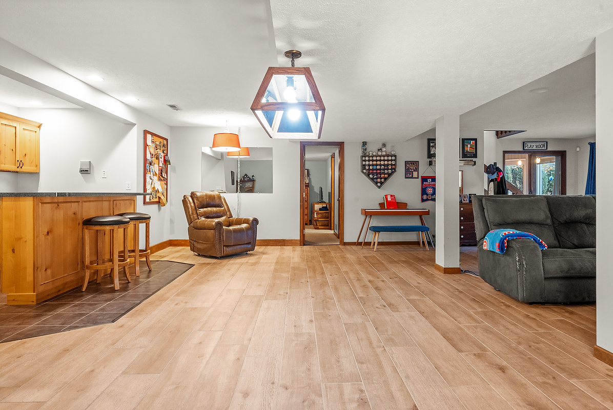 21 Pendleton Way Bloomington, IL 61704 - Photo 42 of 55 a living room with furniture and a chandelier