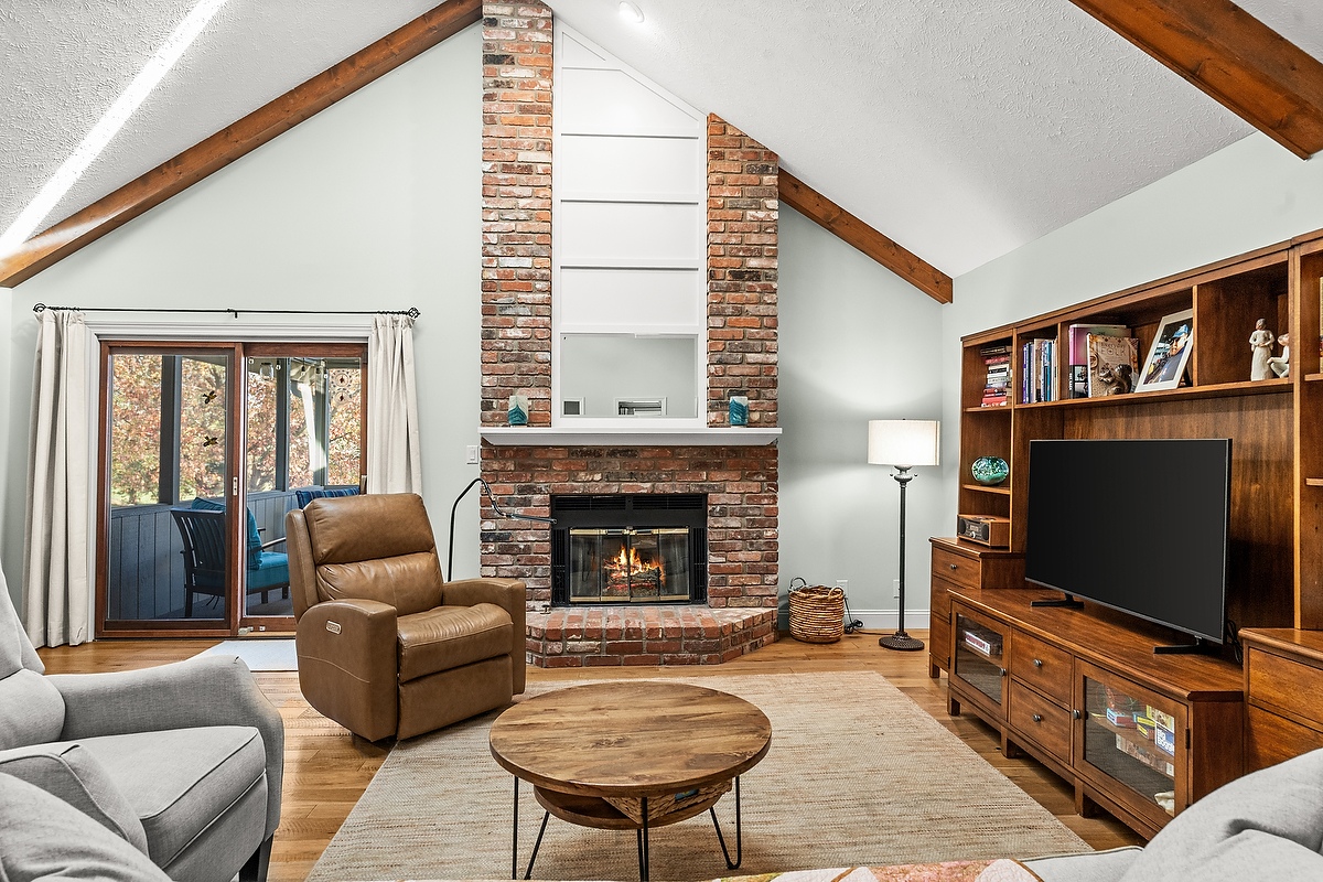 21 Pendleton Way Bloomington, IL 61704 - Photo 6 of 55 a living room with furniture a flat screen tv and a fireplace