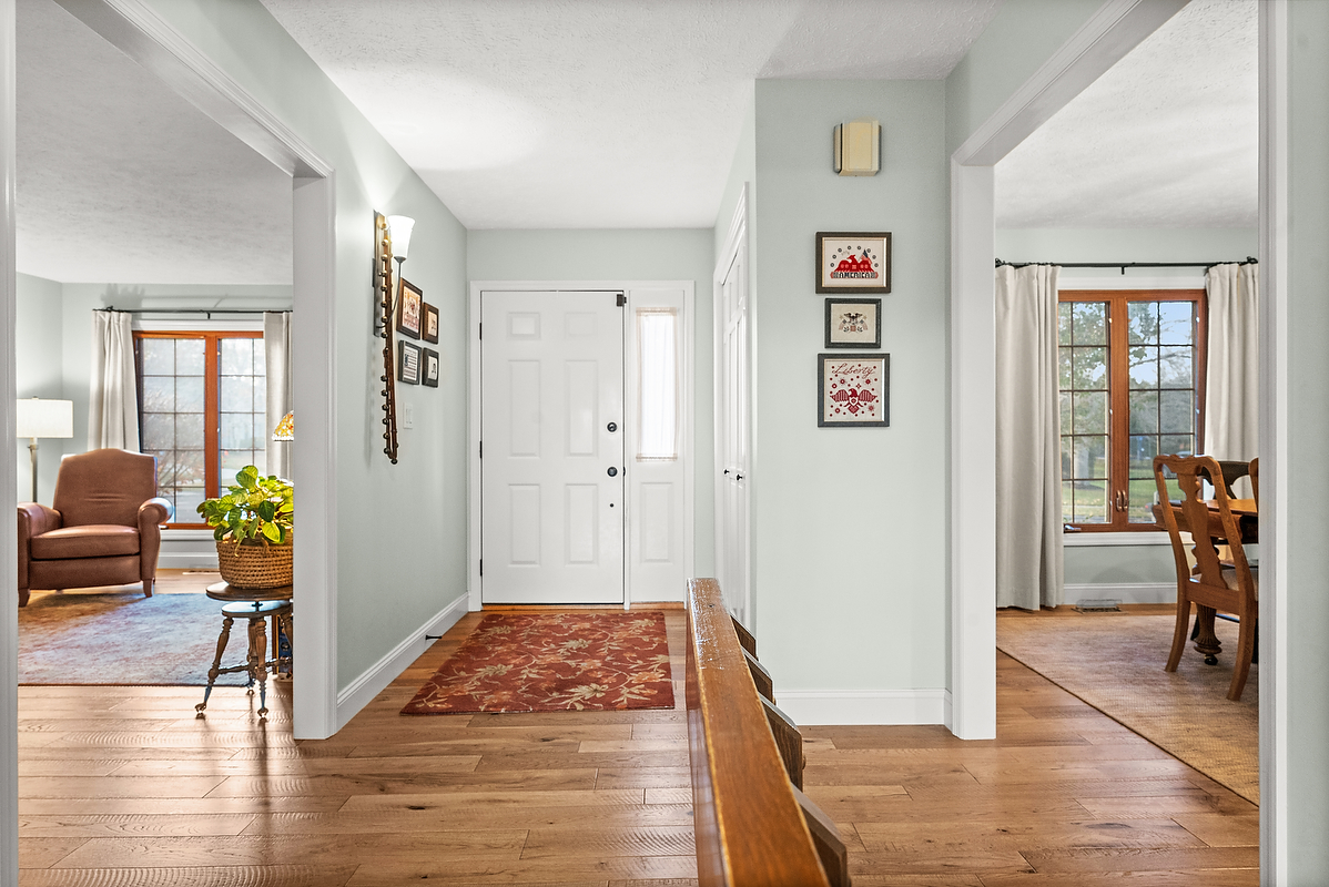 21 Pendleton Way Bloomington, IL 61704 - Photo 7 of 55 a view of a hallway with wooden floor and furniture