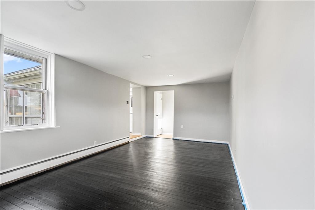 126 Smith Road Sarver, PA 16055 - Photo 5 of 35 a view of an empty room with wooden floor and windows