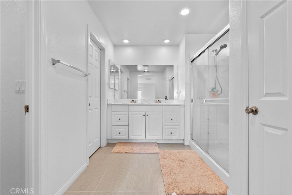 1634 Crepe Myrtle Place Upland, CA 91784 - Photo 17 of 41 a bathroom with a granite countertop sink mirror and shower