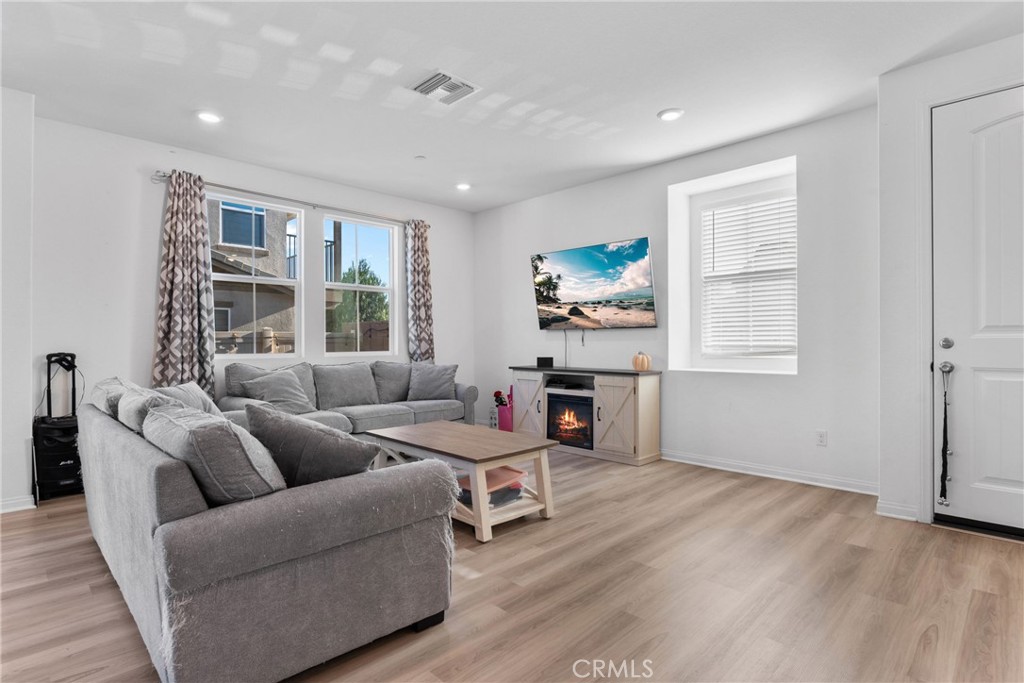 1634 Crepe Myrtle Place Upland, CA 91784 - Photo 4 of 41 a living room with furniture a fireplace and a flat screen tv