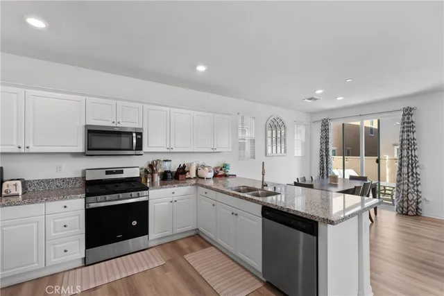 a kitchen with a sink stove and cabinets